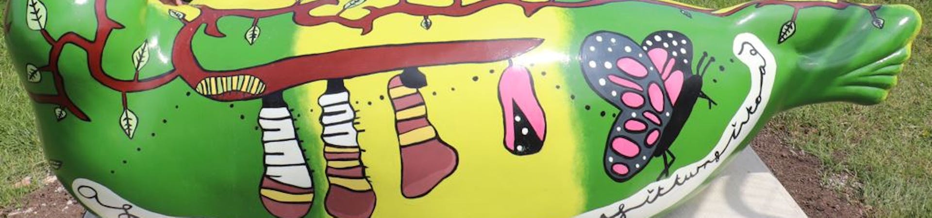 Back view of the bug hotel seal designed by Carleigh Barker and Rosie Harris, showing the life cycle from catepillar to butterfly