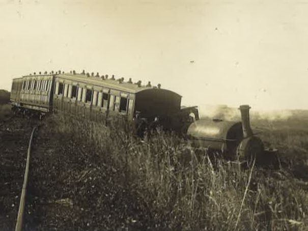 Black and white image showing a derailed tram off the rails