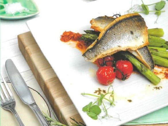 White square plate with fillet of fish with cherry tomatoes