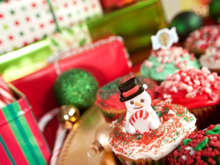Christmas presents and cakes decorated with snowmen and sprinkles