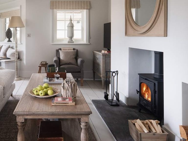 The Wishing Well Photograph of a living room showing a woodburning fire