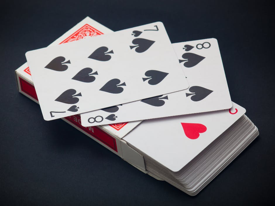 Pack of playing cards with the 7 and 8 of spades and underneath the 2 of hearts