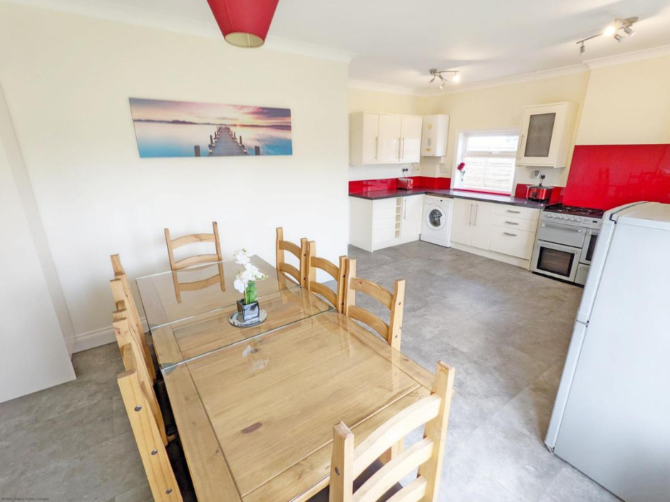 Photograph of a large kitchen with dining table seating eight