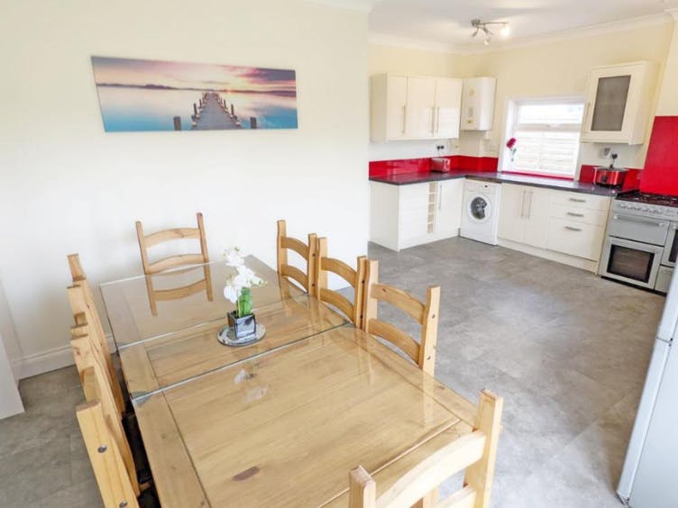 Photograph of a large kitchen with dining table seating eight