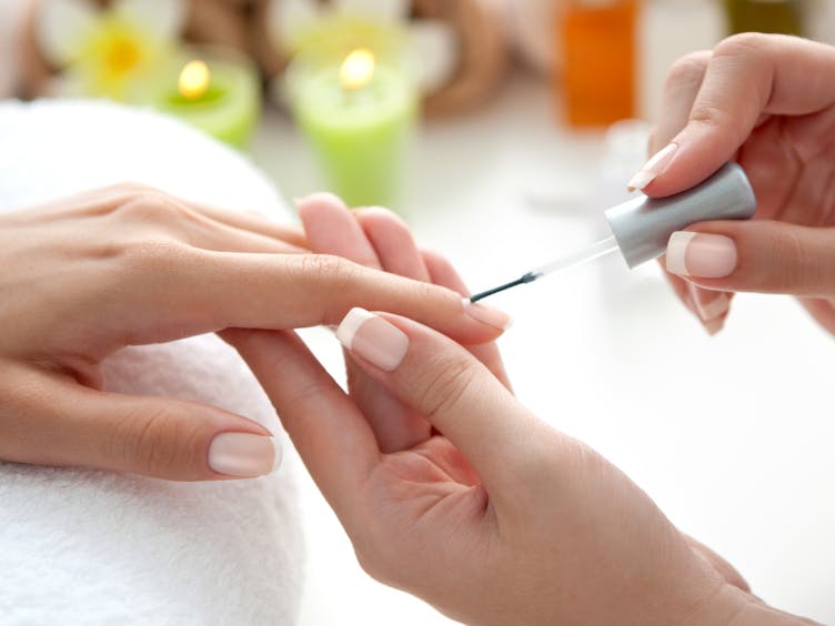 Photograph of finger nails being painted