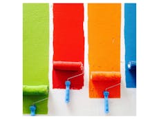 Photograph of 4 different colours being applied by paint rollers