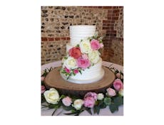 Photograpf of a three tier wedding cake with flowers