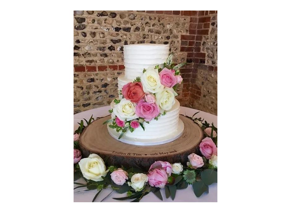 Photograpf of a three tier wedding cake with flowers