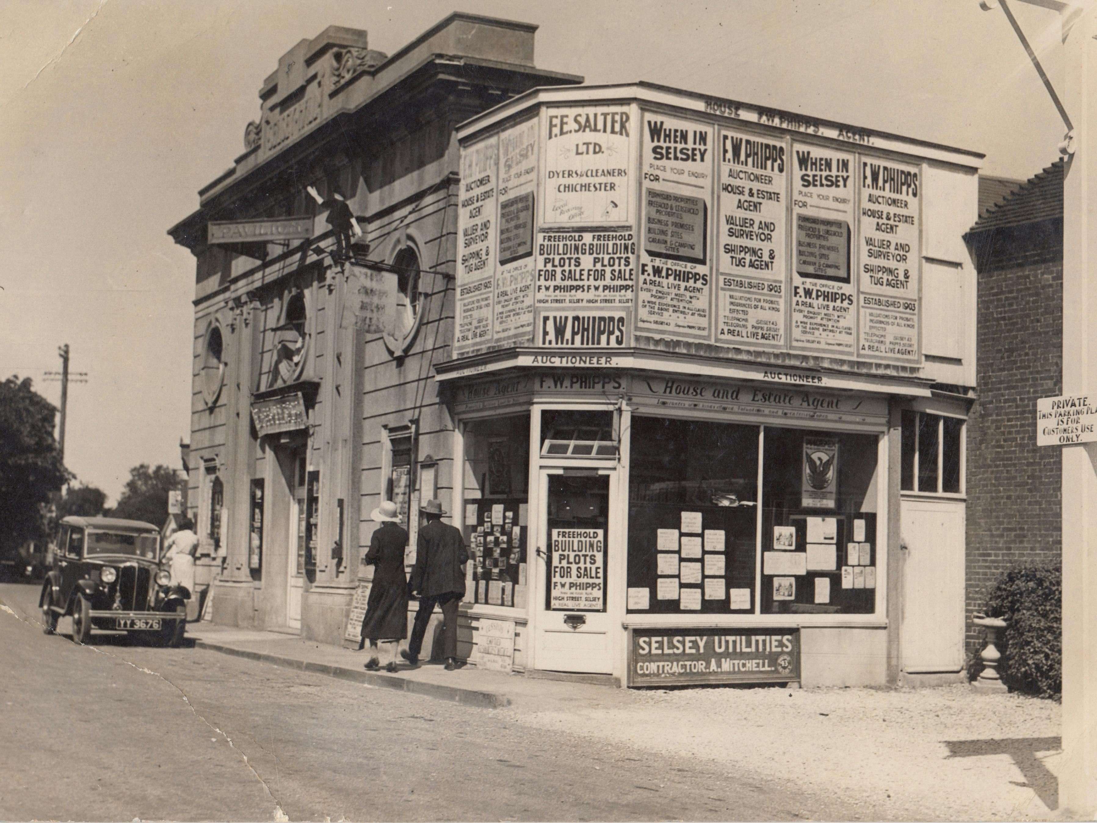 Image of the Selsey Pavilion in the 1920s with the addition of the shop building attached to the site and a old motorcar parked outside