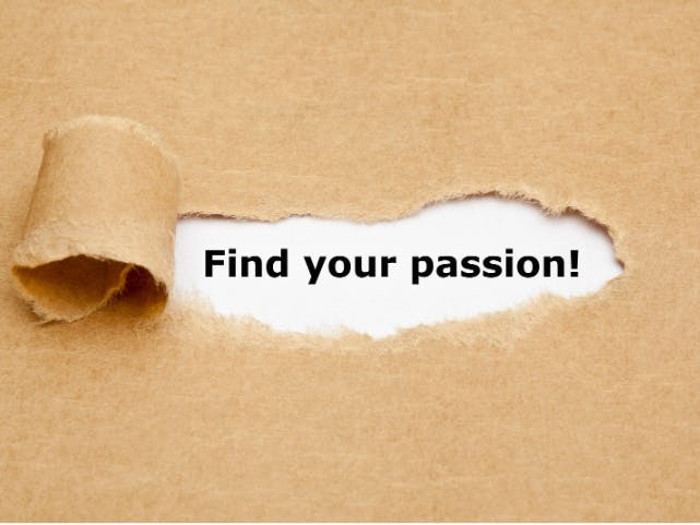Photo of brown paper with a curled tear revealing the words Find Your Passion