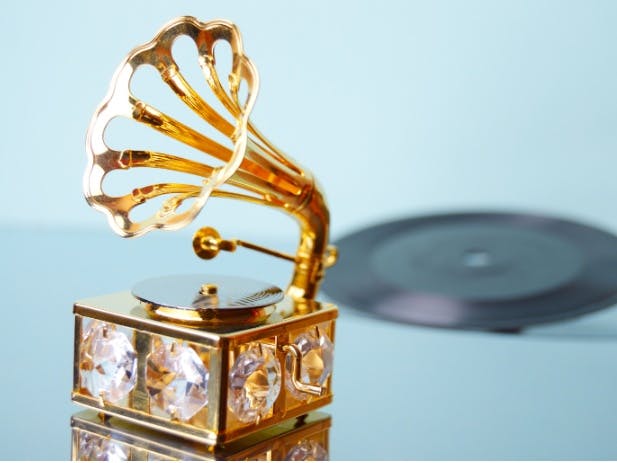 Photograph of a jewelled gramaphone with a record in the background