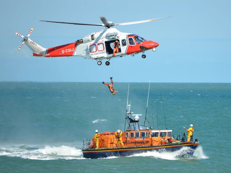 Image courtesy of the Selsey Camera Club Photograph of a coastguard helicopter carrying out a rescue maneuver over a RNLI Lifeboat
