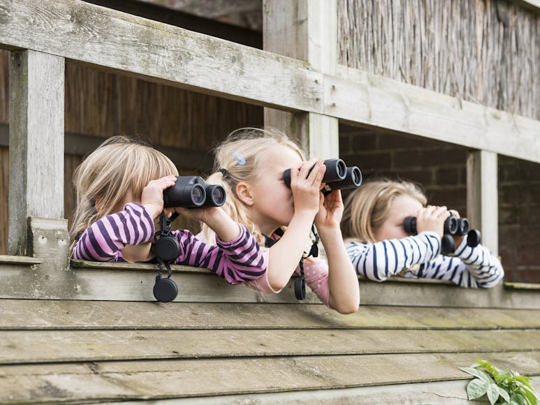 Birdwatching courtesy of Phil Barnes (rspb-images.com) Photograph of three children with binoculars in a bird hide