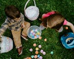 Photograph of two children with easter eggs and baskets