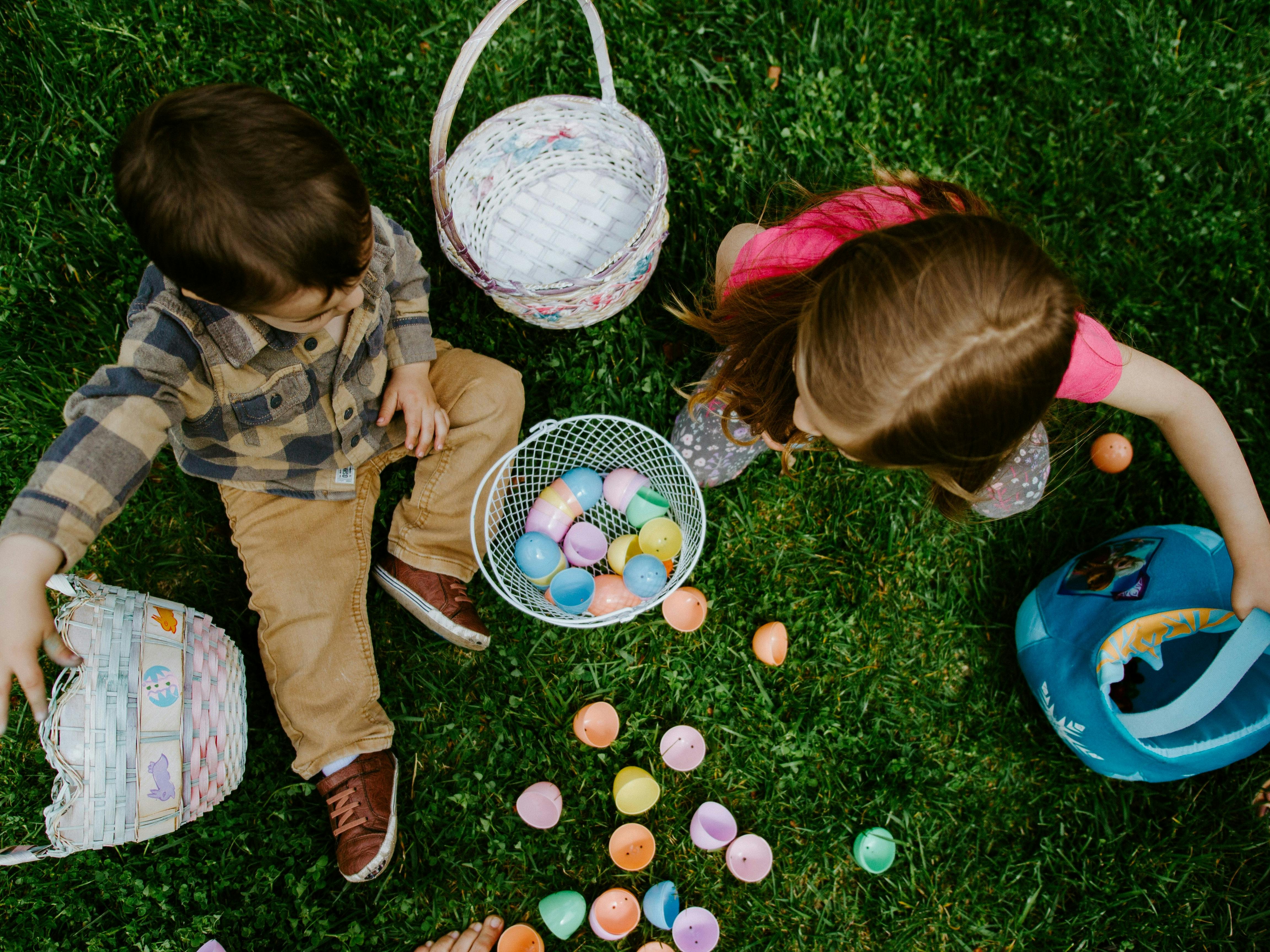 Photograph of two children with easter eggs and baskets