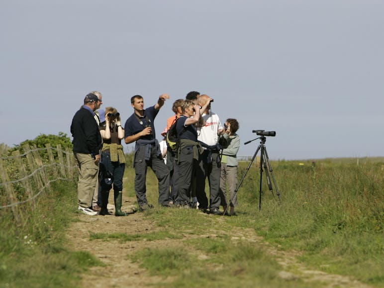 Guiding at the RSPB Nature Reserve courtesy of Andy Hay (rspb-images.com) Photograph of a group of bird watchers with binoculars