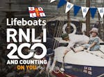 Poster advertising 200 years of the RNLI Lifeboats with the image of a child sat on an old lifeboat looking directly at the camera, set around the 1920s