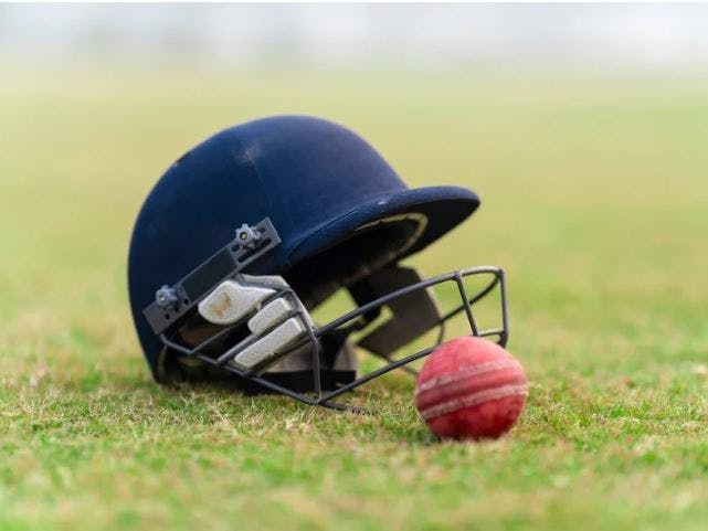 Cricket Helmet & Bat courtesy of Yogendra Singh on canva.com Photograph of a blue cricket helmet and red cricket ball on grass
