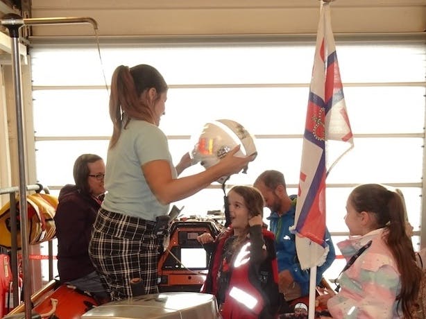 Photograph of kids trying on lifeboat equipment at Selsey Lifeboat week