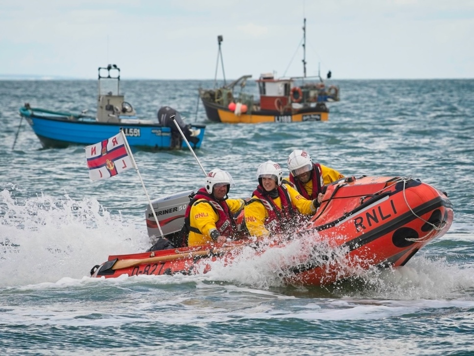 Selsey Lifeboat Crew on the inshore craft with two fishing boats in the background