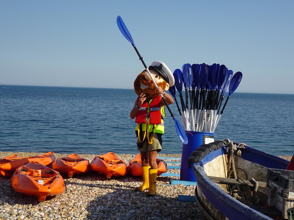 Photograph of kayaks, paddles and RNLI Selsey Mascot