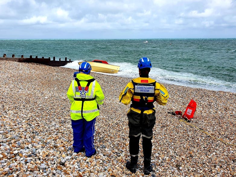 Selsey Coastguards looking out at East Beach courtesy Ashley Pledger Photograph of two of Selsey Coastguards looking out at East Beach