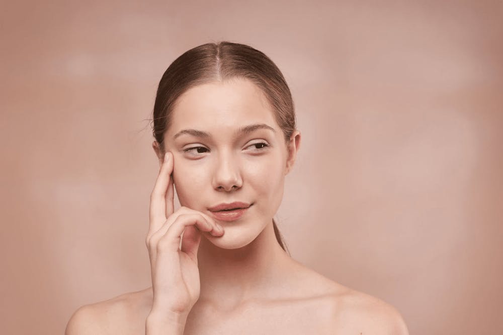woman touching the side of her face