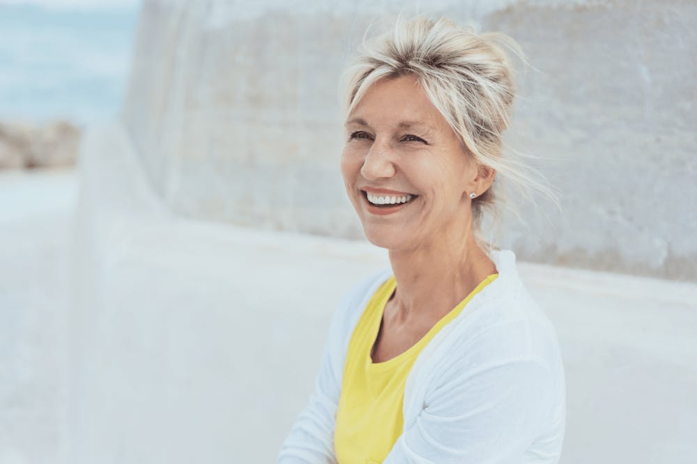 woman in a yellow shirt smiling