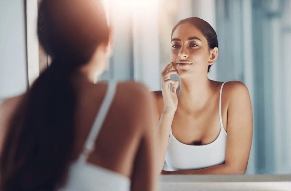 woman looking in the mirror