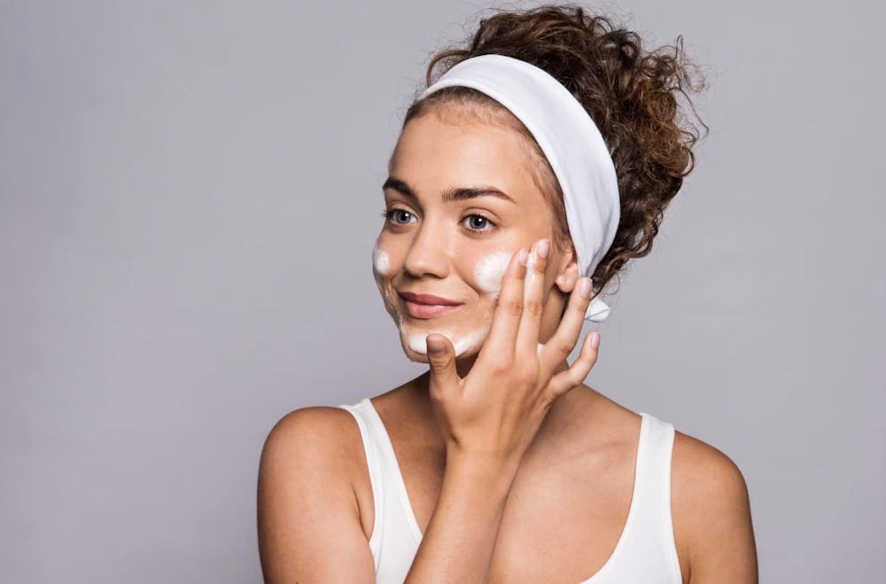 woman washing her face