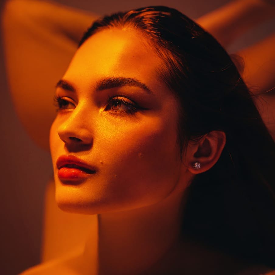 woman under an orange light