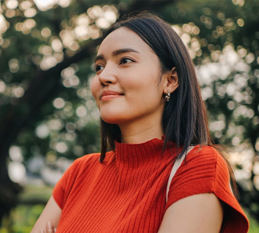 woman smiling, looking to the side