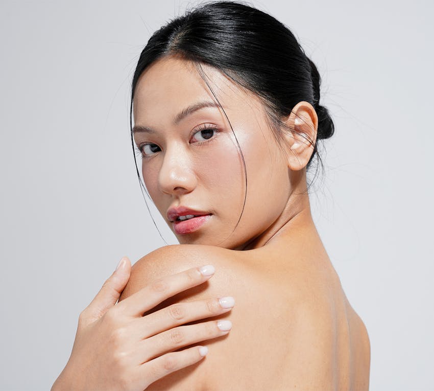 women posing holding her shoulder