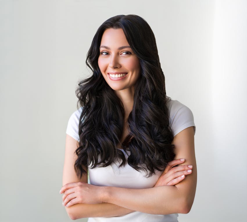 woman smiling with arms crossed