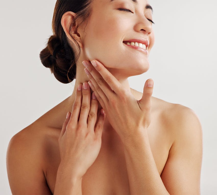 woman touching her neck