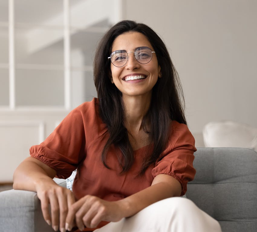 woman sitting on couch smiling