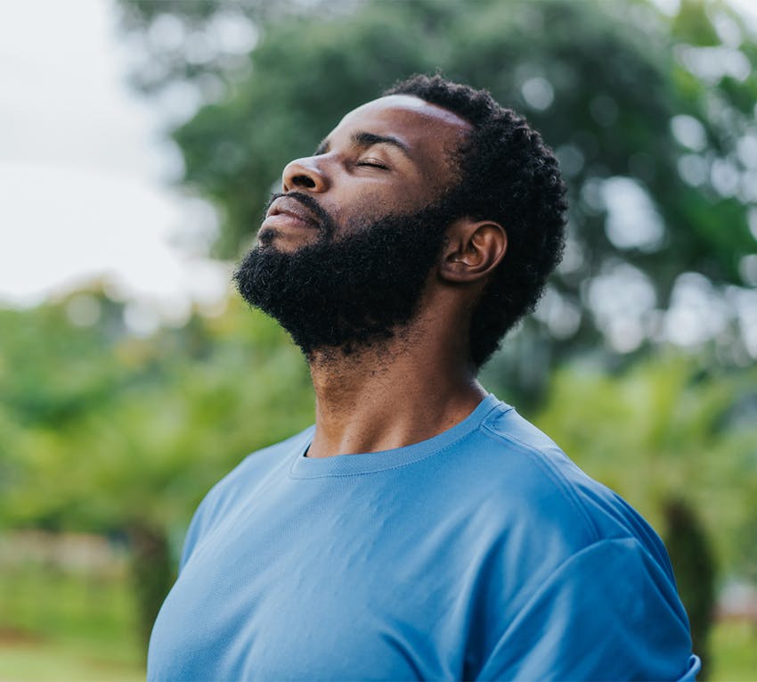 man closing his eyes with his head angled up