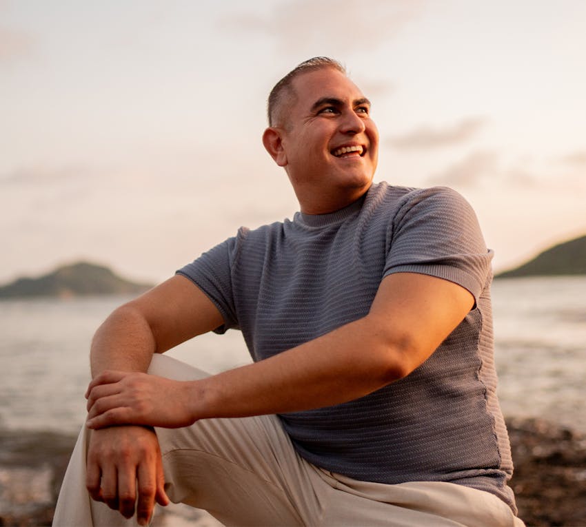 man sitting outside smiling