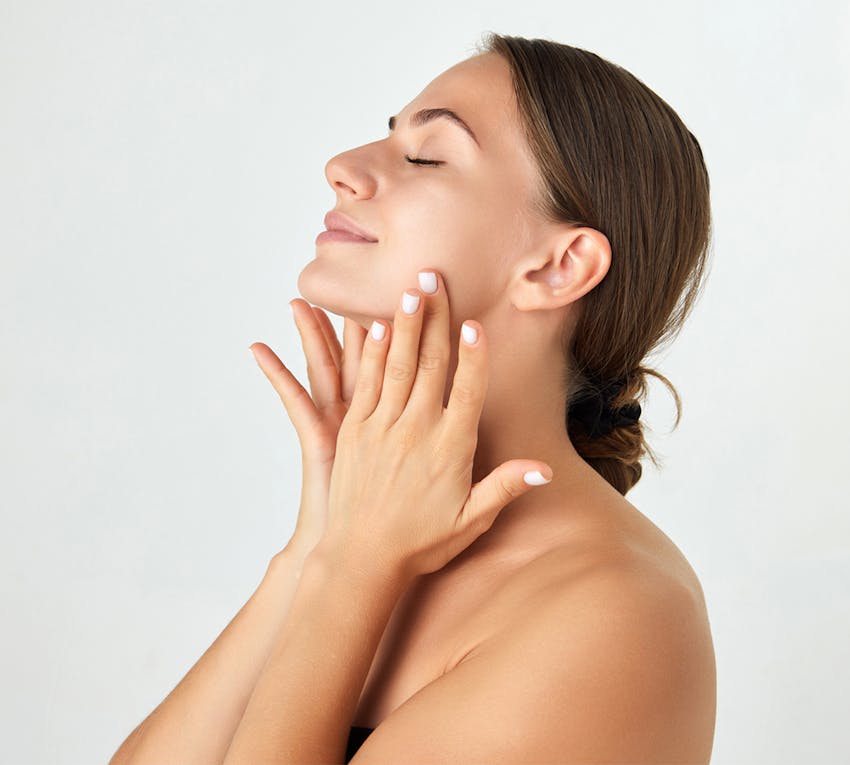 Woman touching her face