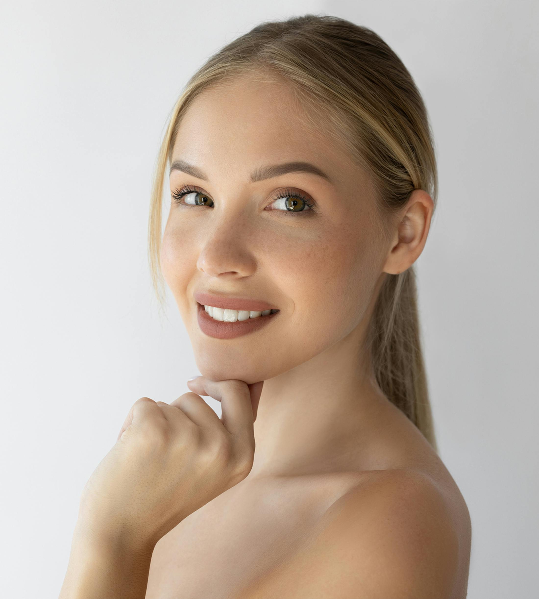 women touching chin smiling