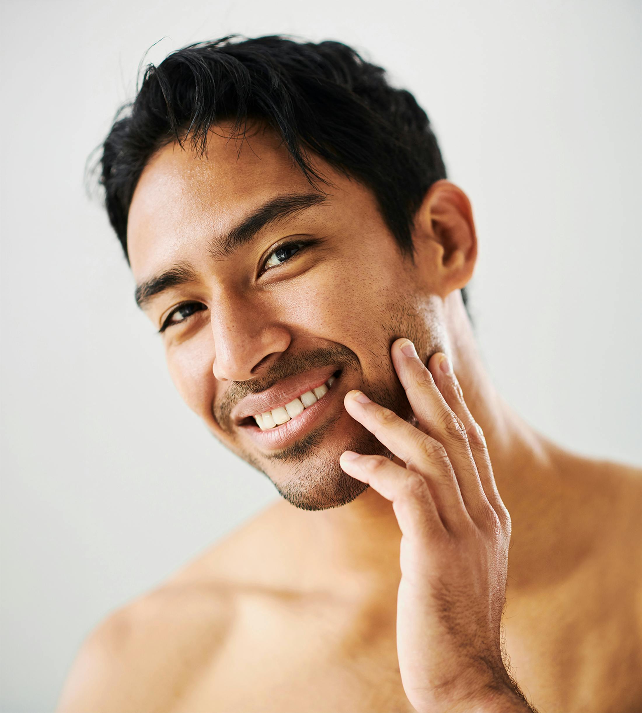 man touching his face