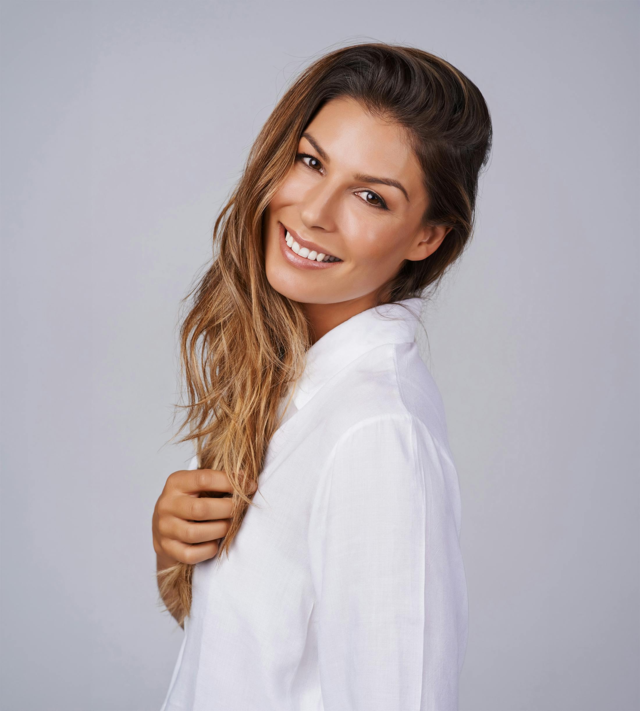 woman smiling over her shoulder