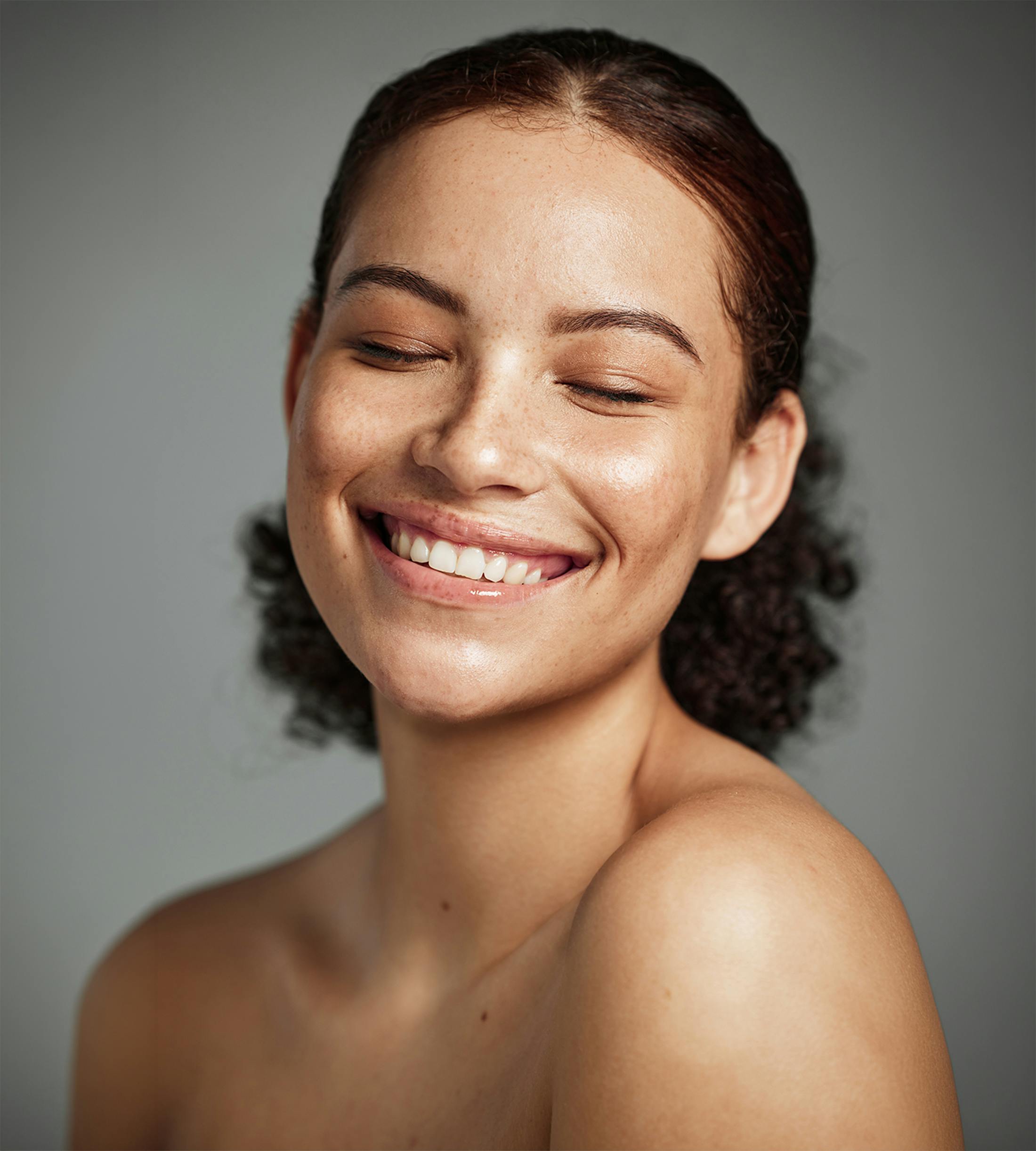 woman smiling with her eyes closed