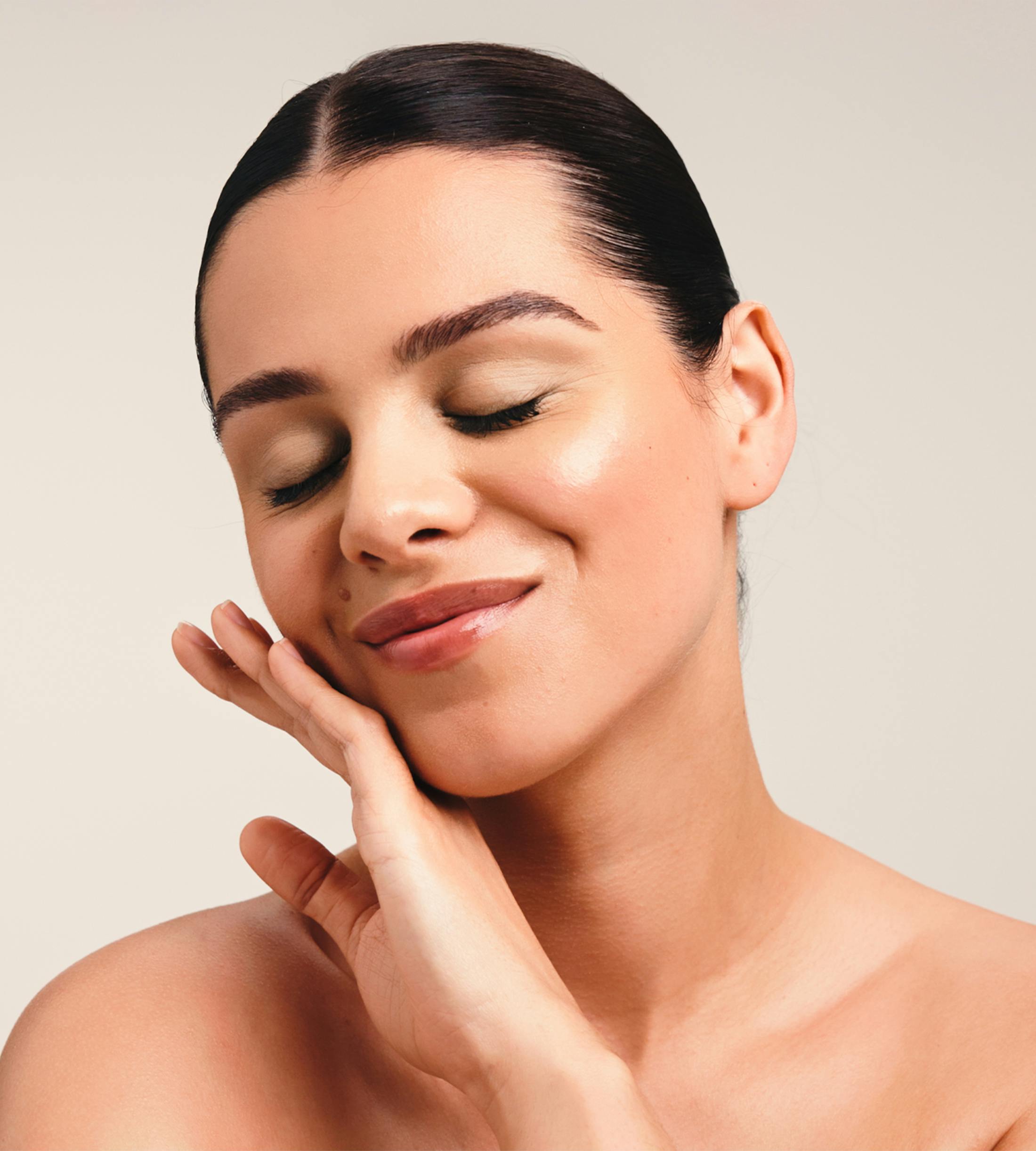woman touching her face with the back of her hand