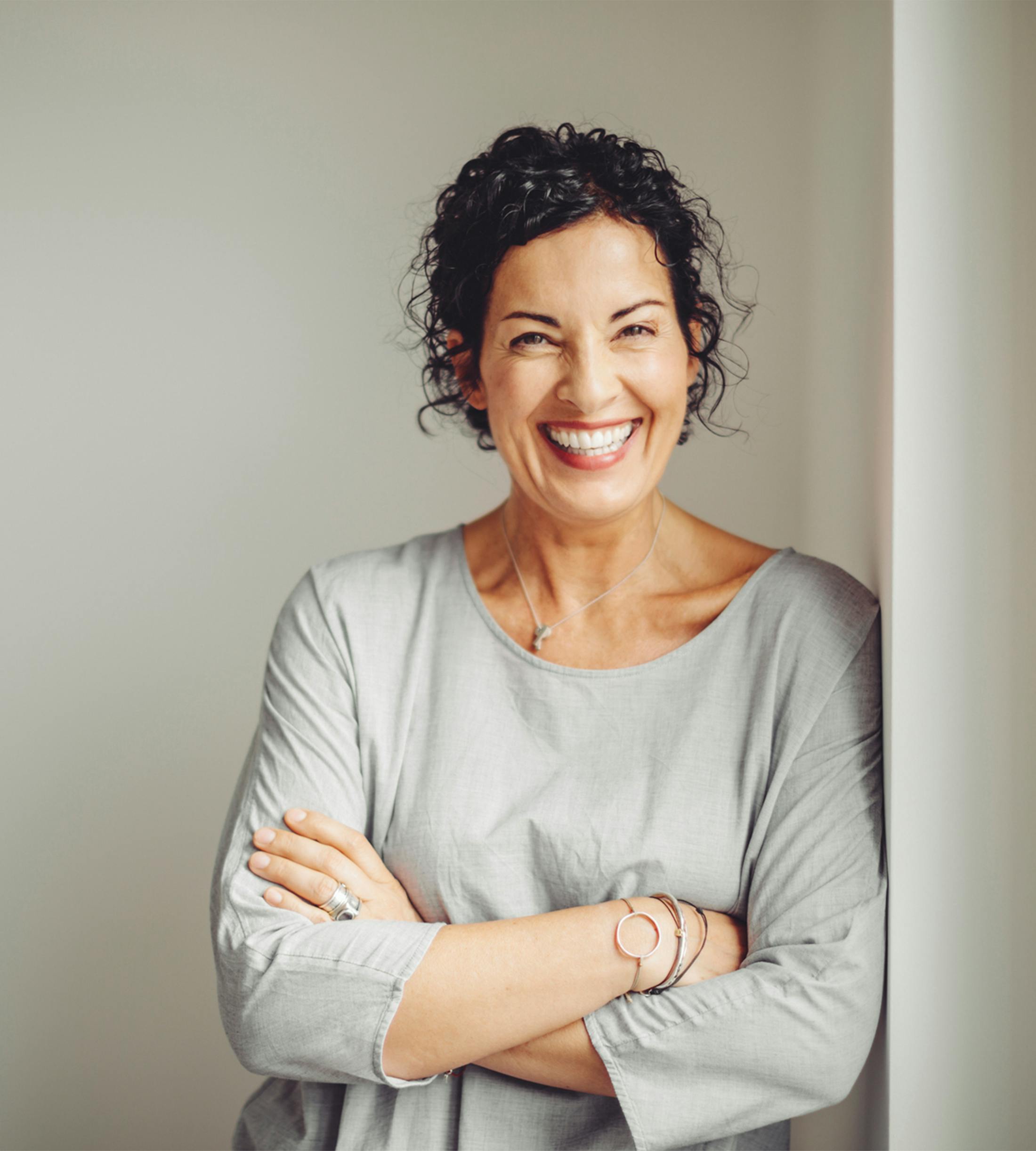 women crossing arms and smiling