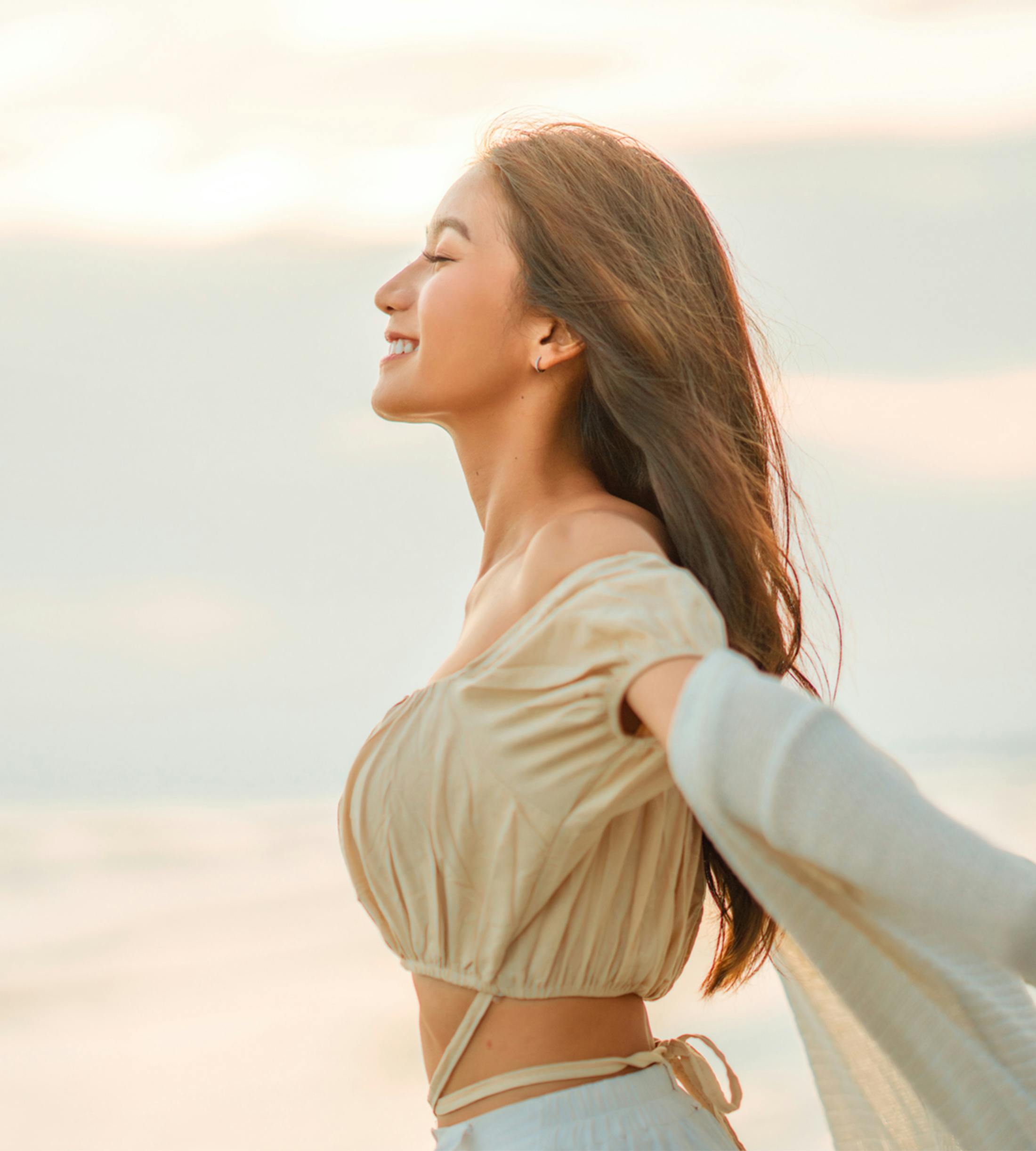 woman smiling with her arms spread out