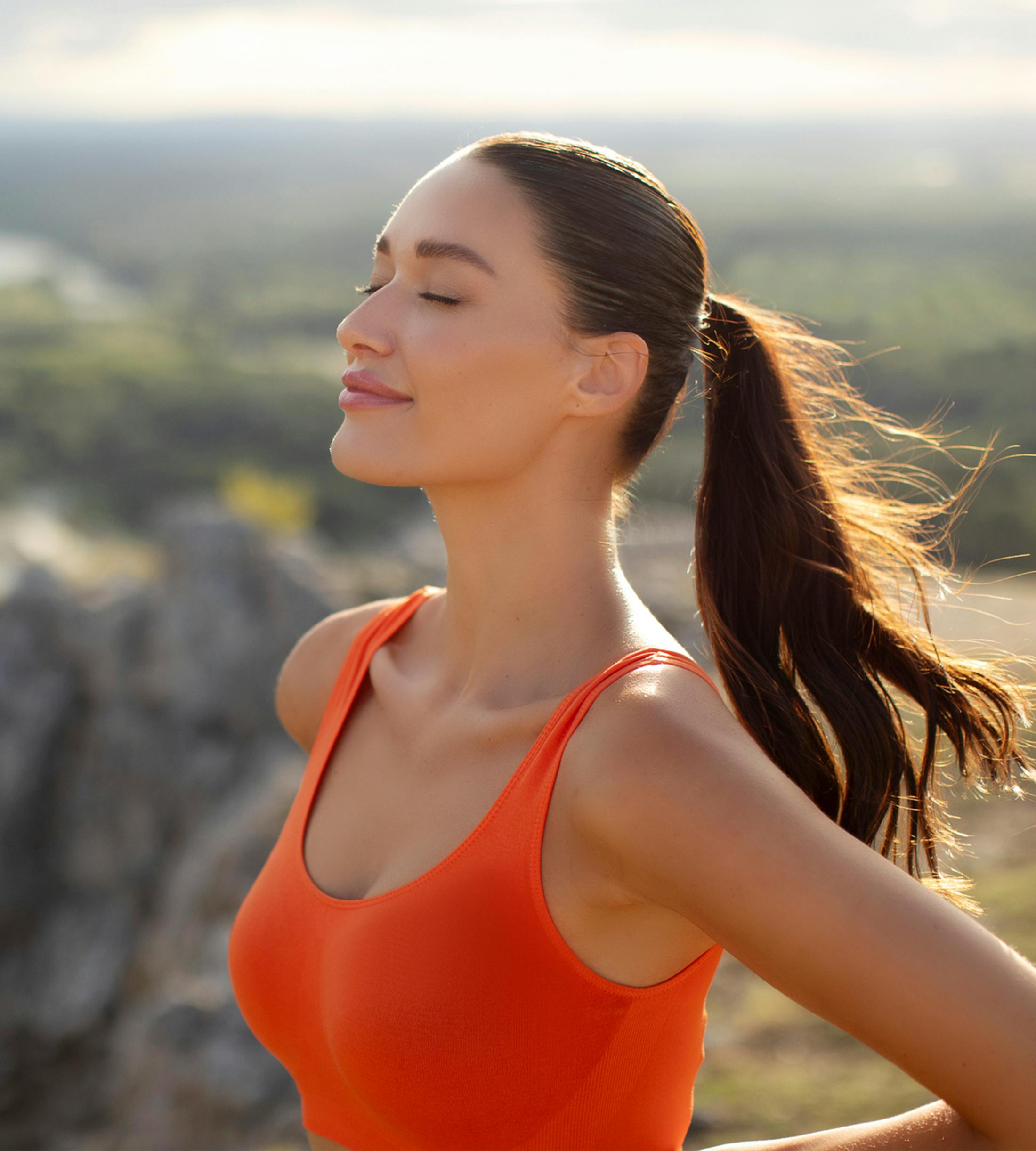 women standing outdoors with eyes closed