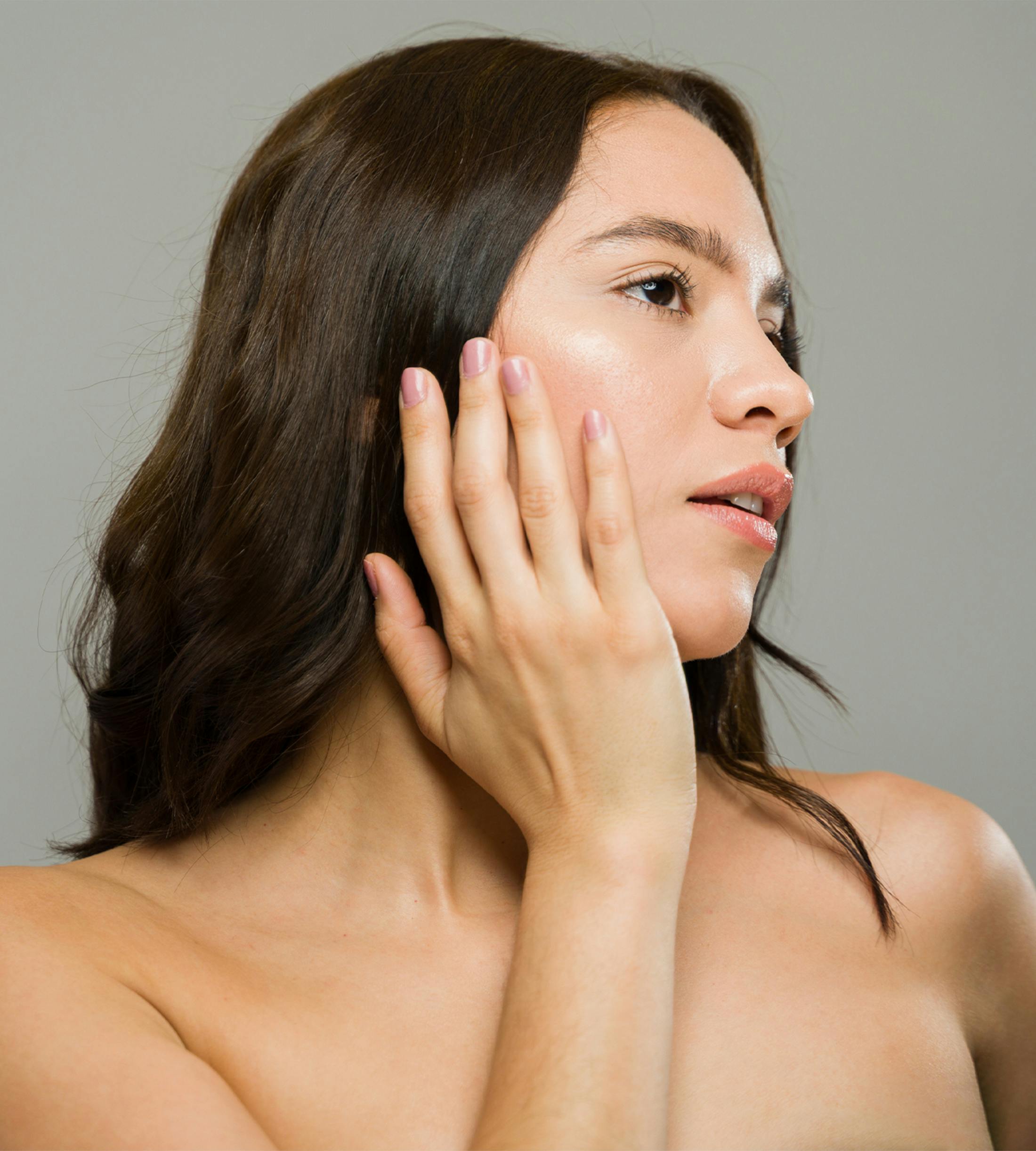 woman touching her face