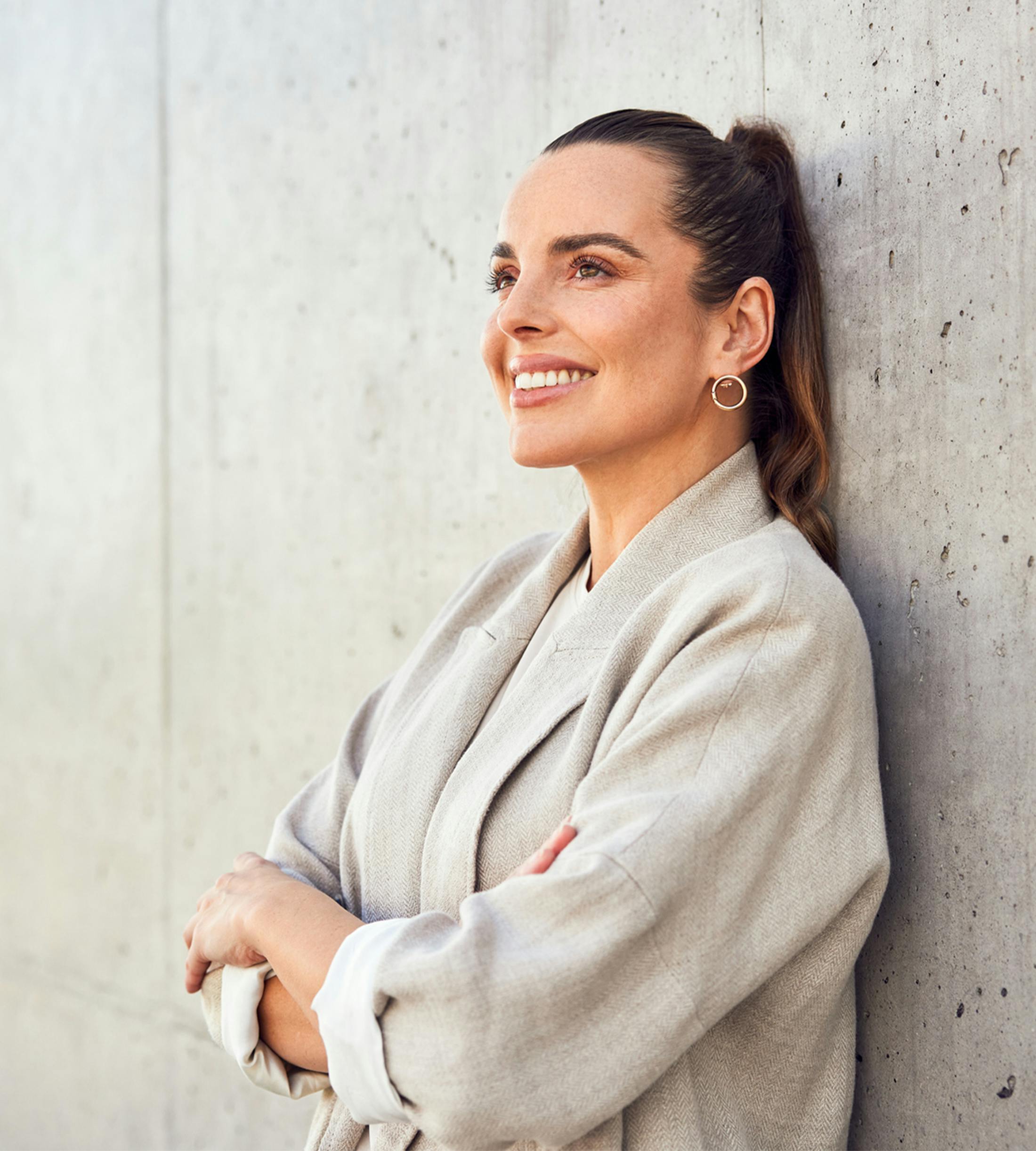 woman smiling leaning against wall