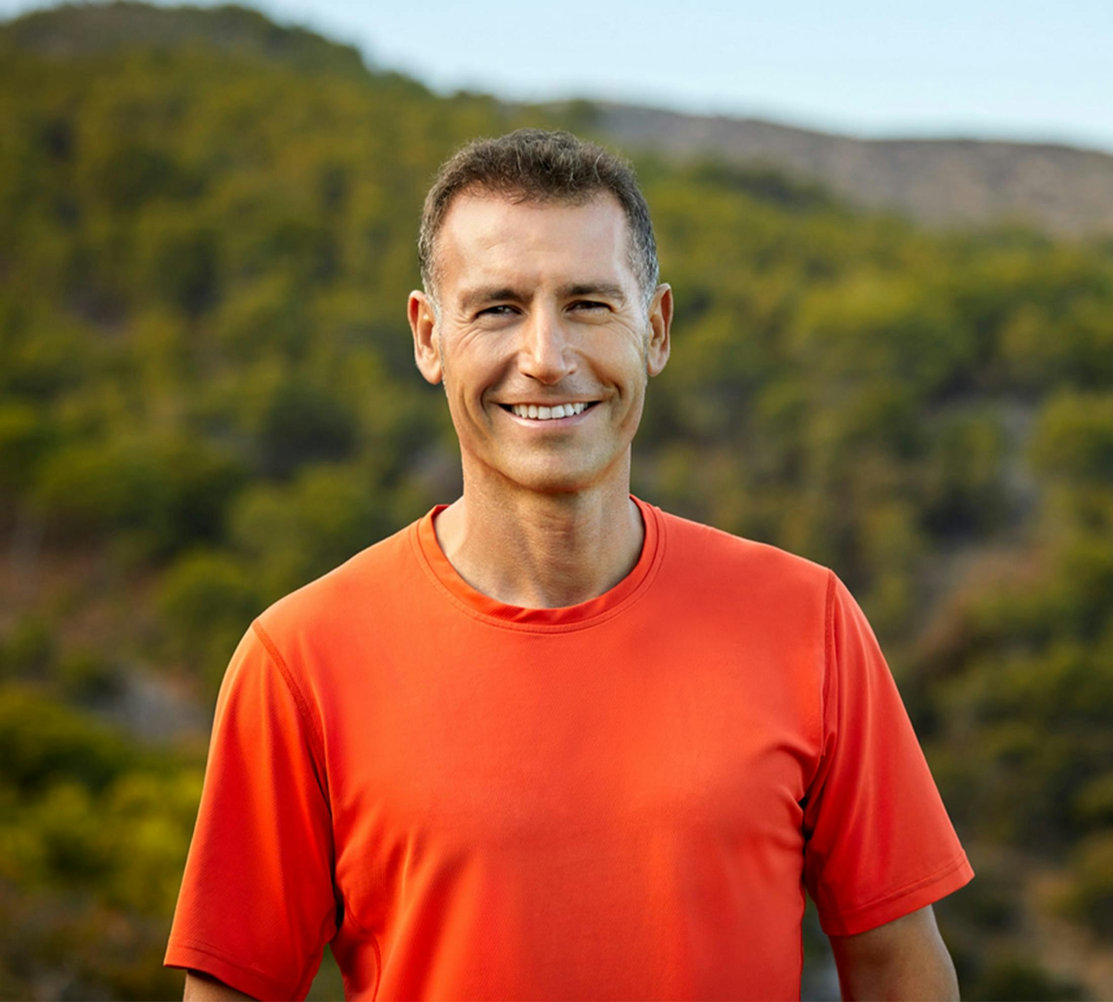 man in an orange shirt outside